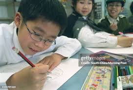Primary Two pupil Duncan Wu Bing-ji, eight, in an art lesson at HKUGA...  News Photo