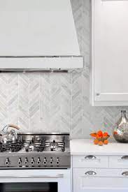 A backsplash with blue, turquoise, and seafoam green paired up with white cabinets will practically transport you to the beach. White Modern Marble Chevron Backsplash Tile Backsplash Com