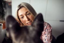 La Bella Dueña Rubia Examina a Su Mascota Peruana La Pone En La Mesa  Delante De Ella. Mascotas Sanas. Momentos Felices. Imagen de archivo
