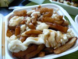 Poutine is a popular canadian fast food dish that is made with french fries that are covered in cheese curds and gravy. What Is Poutine Canadian Gravy Fries With Cheese Curds News Vdw
