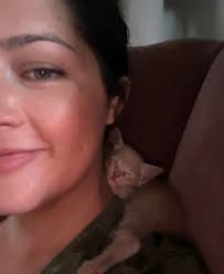 Inspired by Dessie Mazhar 's Petunia, we put Ash in her christmas dress  again! Clearly she loves it (her face is just comfy like this, she was  purring, i promise hahaha) |