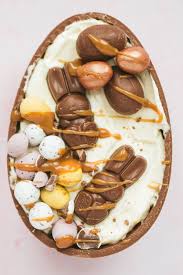 11 creme egg dessert recipes: Half A Chocolate Easter Egg Filled With A No Bake Cheesecake Filling And Lots Of Easter Treats Easter Eggs Chocolate Easter Baking Easter Egg Dessert