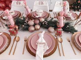 A cozy traditional table setting with evergreens, pinecones, plaid napkins and ornaments. Blushing Brunch Bubbly Holiday Party Kara S Party Ideas Rose Gold Christmas Rose Gold Christmas Decorations Pink Christmas Decorations