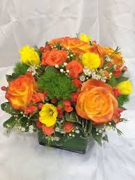 Beautiful Orange Roses With Green Trick Dianthus Daffodils Wax Flower Make For A Bright Sunny Arrangemen Peach Flowers Flower Arrangements Dahlias Wedding