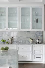 Fixed Against A Gray And Blue Marble Slab Backsplash Glass Front Cabinets Ar In 2020 Glass Fronted Kitchen Cabinets Glass Kitchen Cabinets Glass Kitchen Cabinet Doors
