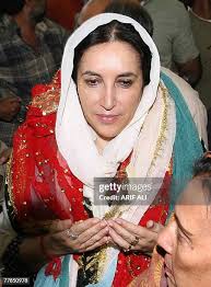 Former Pakistani prime minister Benazir Bhutto prays at a shrine of... News  Photo