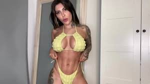 Italian beauty with a gorgeous figure cant figure out which swimsuit suits  her best.