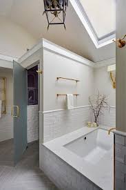 Vaulted Ceiling In A Master Bathroom Features A Skylight Over A Bathtub Nook Fitted With White Small Apartment Bathroom Top Bathroom Design Luxury Spa Bathroom