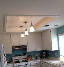 Lighting a kitchen with a sloped ceiling can be a chore, but there are still stylish solutions to choose from. Gorgeous Kitchen Fluorescent Light Box Remodel With Wood Beadboard Ceiling Panels In White Paint Fin Kitchen Lighting Remodel Kitchen Ceiling Lighting Makeover