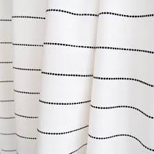 The sheer window panel with a subtle grey stripe running vertically along the curtain is a décor dream. Emile Stripe Cotton Onyx Tonic Living