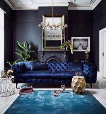 Pale shades of blue, linen, and white grace this living room in an elegant tribute to old hollywood. 28 Gorgeous Living Rooms With Black Walls That Create Cozy Drama