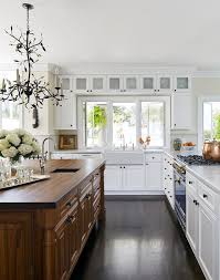 Black And White Kitchen With Wood Countertops Lovely Crisp White Kitchen With Dark Stained Walnut Island Farmhouse Sink And Wood Countertop Kitchen Cabinet Design Kitchen Remodel Rustic Farmhouse Kitchen
