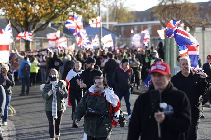Hundreds join anti-migrant march near planned immigration removal centre | The Independent