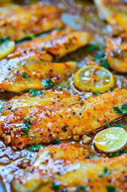 Spicy Lemon Garlic Baked Tilapia On A Baking Tray Tilapia Dinner Recipe Recipes Tilapia Dinner