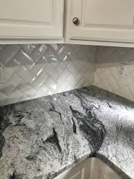 The backsplash is a beige color. Our Kitchen Renovation White Granite Countertops Beveled Subway Tile Granite Countertops