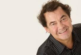 Simon May faces the glare of the Spotlight