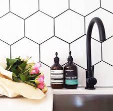 If you want to create a pop but in a less drastic way than you would get with black grout, a light gray grout or medium gray grout is the way to go. Using Dark Grout