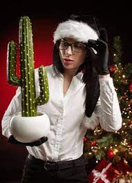 A Woman In A Black Santa Hat Holds A Cactus In Her Hand Ad Ad Santa Black Woman Hat Hand Black Santa Hat Women Santa Hat