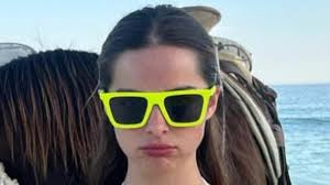 Addison Rae showcases her figure in a white bikini as she poses with horses 