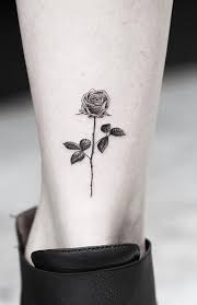 A vibrant red rose tattoo between the shoulders. 100 Rose Tattoos Meanings Tattoo Desings Artists