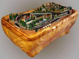 Placed against the wall, with an overstuffed armchair on each side, and a sofa facing the table, the layout becomes an instant conversation starter. Coffee Table Train Table Coffee Addicts Kidd Stuff Modelleisenbahn Modell Models