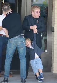 Elton John Playfully Swings Their Son Zachary After A Family Meal Elton John Elton John Partner Elton John Husband