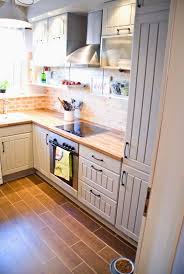 Small Kitchen With Two Tone Cabinets Wood Tile Floors Pudel Design Featured On Remodelaholic Kitchen Design Small Kitchen Remodel Small Tiny House Kitchen