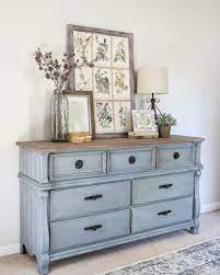 Add an old, worn look to a piece of painted furniture by distressing to show a bit of the wear and tear of daily life. French Blue Dresser Makeover Refurbished Furniture Furniture Makeover Farmhouse Furniture