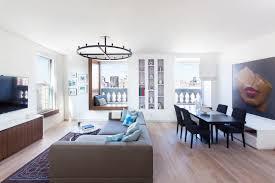 Paintings in the style of franz kline hang over the living room sofa. Two Apartments Become A Modern Nyc Home Design Milk