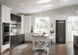 A White Open Plan Kitchen With A Black Refrigerator Kitchen Design Black Appliances Kitchen Black Stainless Steel Appliances