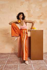 To realize really cool boudoir photography outfit ideas, put on white tops, jeans or shorts. Fe Essentials I Fe Noel Orange Fashion Editorial Fashion Fashion Photoshoot