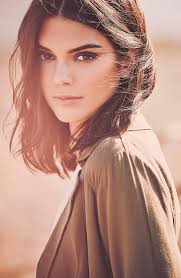 The portrait of a guy model with blue eyes and blond hair in the image of a girl with beads around neck. Kendall Jenner Women Model Brunette Dark Hair Women Outdoors Shoulder Length Hair Hd Wallpaper Wallpaperbetter