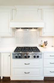 If you're considering stove backsplash panels, like mosaic tile on mesh backing, installation will require tools and supplies like tile adhesive, grout, a trowel, grout float and more. White Herringbone Cooktop Tile Backsplash Transitional Kitchen