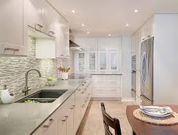 The bright kitchen showcases sleek cabinets, wooden dining set and a stone top island opposite the fireplace. 20 Dashing And Streamlined Modern Condo Kitchen Designs Home Design Lover