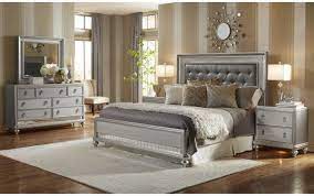 Finished in a striking silver tone and accented with silver pendant drawer pulls, this set is perfect for those who want a dramatic aura in their bedroom. Samuel Lawrence Furniture Diva Queen Bed Plus Dresser Mirror And Nightstand 8808 255 257 400 010 030 050 Miskelly Furniture