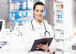 At Pharmacy A Smiling Young Woman Pharmacist Wearing Stethoscope Holding A Medi Sponsored Affiliate Ad Young Pha Pharmacy Pharmacy Design Pharmacist