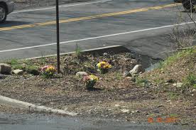 A memorial of roses and sunflowers is growing outside of Spencer ...