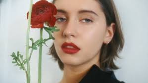 Iris Law looks bronzed and beaming as she celebrates the New Year splashing  in the surf