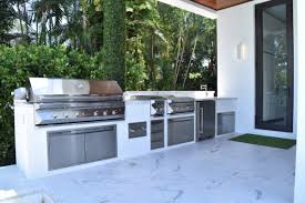 Overlooking the swimming pool is an ideal place for this outdoor kitchen with curved countertop and bar stool seating. Twin Eagles Outdoor Kitchen Straight Luxapatio
