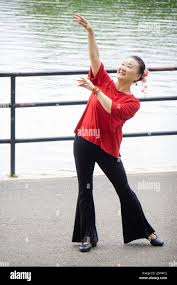An attractive graceful Asian American woman who loves to dance poses for  photos near a lake in a park in Queens,, New York City Stock Photo - Alamy