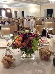 Backyard wedding decor, wedding table decor, outdoor party, dinner table, lighting, patio party, led string lights *wine bottles not incl. Wine Themed Centerpieces Cork Filled Upside Down Wine Glasses As Candle Bases Event Center Wine Glass Centerpieces Wine Theme Wedding Wedding Centerpieces