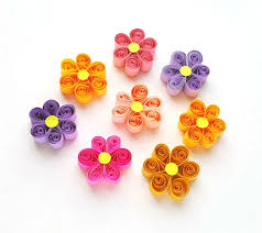 Paper quilling is the art of taking thin strips of colored paper, rolling them into a coil, pinching them to form a shape and then gluing the shapes together to create paper designs and objects. Paper Quilling Wreath With Easy Quilled Paper Flowers