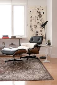 The Eames Lounge Chair And Ottoman By Herman Miller Are Accompanied By The Saarinen Side Table By Knoll The Lamp From Eames Lounge Chair Home Decor Furniture