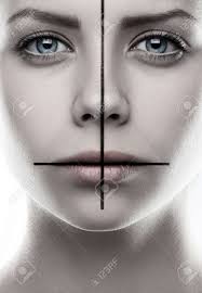 Portrait Of A Girl With A Cross On The Face, Make-up Cross, Inverted Cross,  The Symbol Of St. Peter, St. Peter's Cross, White Background, Isolated,  Religion, Vampire In Studio Stock Photo, Picture