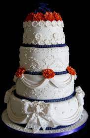 Four Layer Wedding Cakes Drapes Bows And Flowers Chocolate Wedding Cake Elegant Wedding Cakes Wedding Cakes