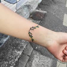 Olive Wreath Tattoo On The Wrist Tattoo Artist Zihee Olive Branch Tattoo Tattoos Tattoo Designs And Meanings