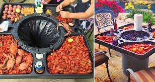 This Table Features A Built In Trash Can So You Can Enjoy Your Seafood Without The Added Mess Crawfish Boil Party How To Cook Crawfish Crab Boil Party
