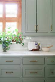 Sage Green Kitchen Cabinets With Brass Hardware And White Subway Tile Backsplash Painted Kitchen Cabinets Colors Green Kitchen Cabinets Kitchen Cabinet Colors