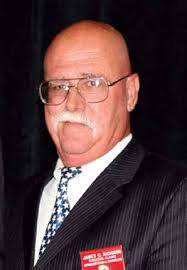 Military servicemembers render honors as fire and rescue workers unfurl a  huge American flag over the side of the Pentagon durin