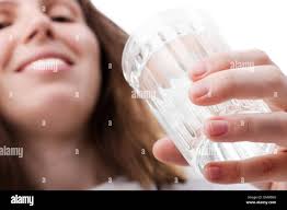 Hand holding glass full of water hi-res stock photography and images